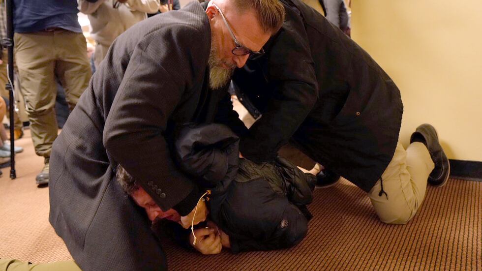 A man is tackled to the ground after spraying an unknown substance on U.S. Rep. Ilhan Omar,...