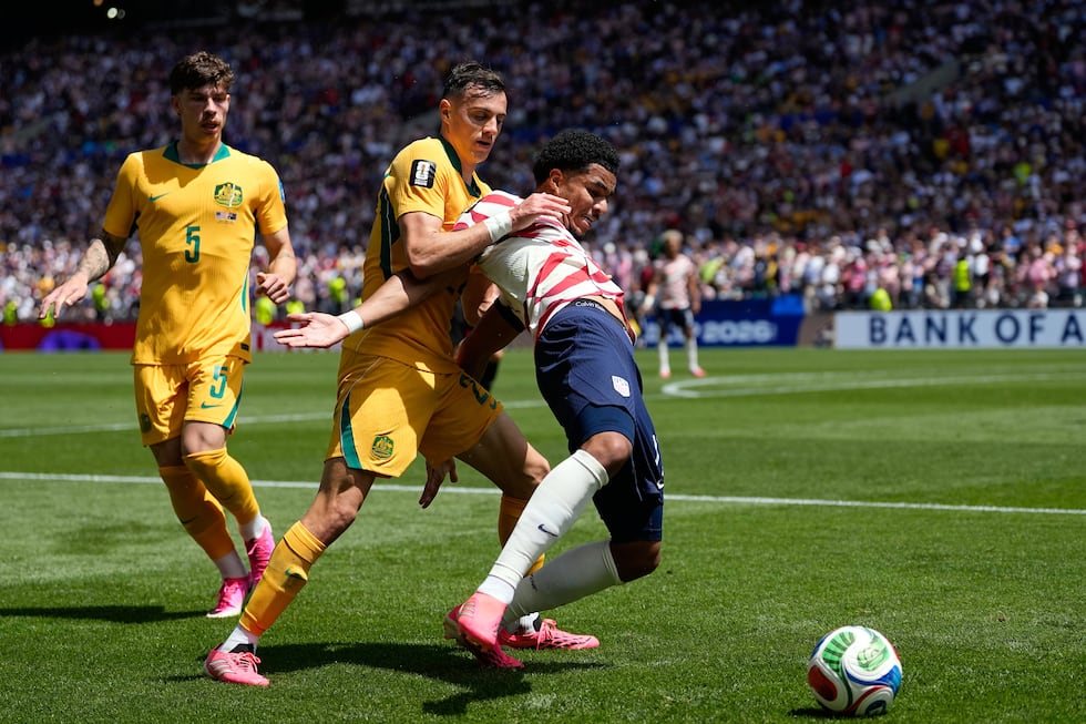 Australia's Paul Okon-Engstler fights for the ball with United States' Weston McKennie, right,...