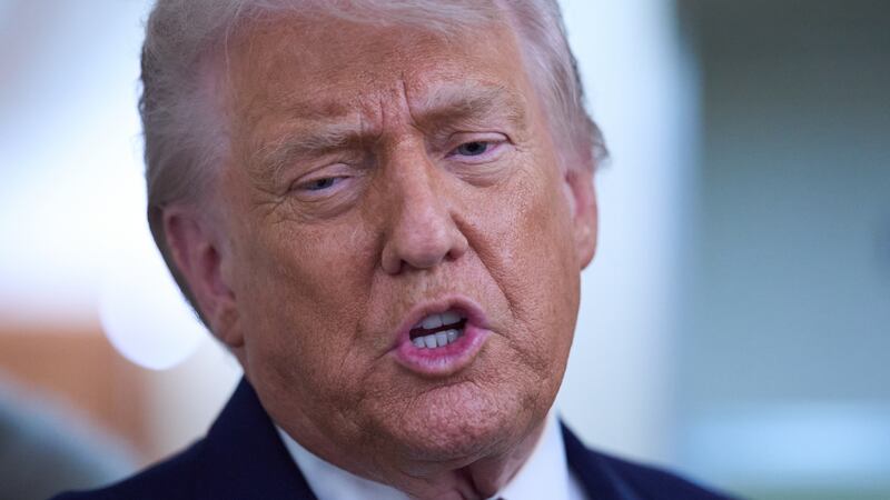 FILE -- President Donald Trump speaks with reporters aboard Air Force One after leaving the...